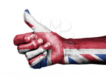 Old woman with arthritis giving the thumbs up sign, wrapped in flag pattern, United Kingdom