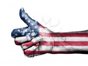 Old woman with arthritis giving the thumbs up sign, wrapped in flag pattern, United States of America