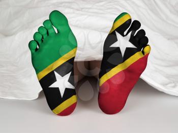 Feet with flag, sleeping or death concept, flag of Saint Kitts and Nevis