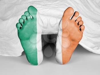 Dead body under a white sheet, flag of Ireland
