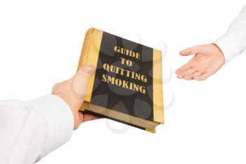Businessman giving an used book to another businessman, guide to quiting smoking