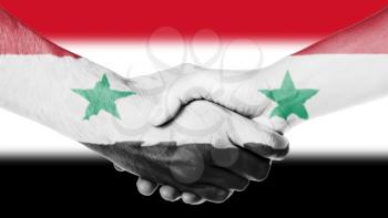Man and woman shaking hands, arms wrapped in the flag of Syria