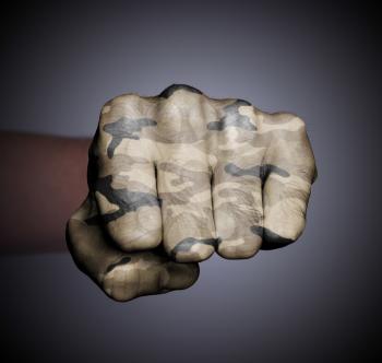 Front view of punching fist on gray background, camouflage