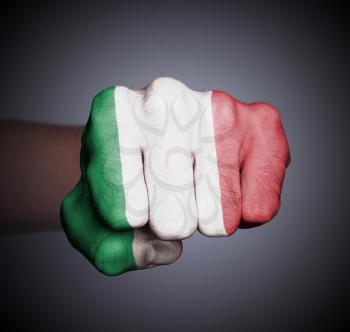 Front view of punching fist on gray background, flag of Italy