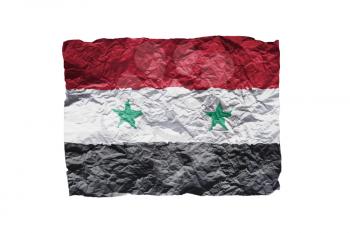 Close up of a curled paper on white background, print of the flag of Syria