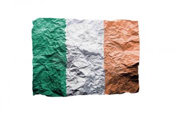 Close up of a curled paper on white background, print of the flag of Ireland