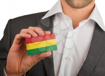 Businessman is holding a business card, flag of Bolivia