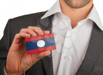 Businessman is holding a business card, flag of Laos