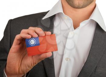 Businessman is holding a business card, flag of Myanmar