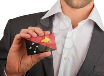 Businessman is holding a business card, flag of Papua New Guinea
