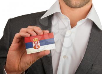 Businessman is holding a business card, flag of Serbia
