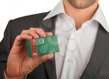 Businessman is holding a business card, flag of Turkmenistan