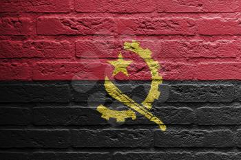 Brick wall with a painting of a flag isolated, Angola