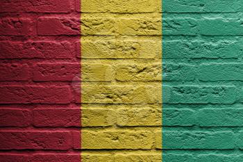 Brick wall with a painting of a flag isolated, Guinea