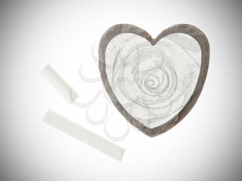 Heart shaped piece of slate over white, chalk drawing of a rose