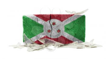 Brick with broken glass, violence concept, flag of Burundi