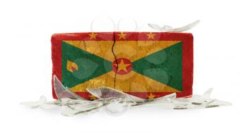 Brick with broken glass, violence concept, flag of Grenada