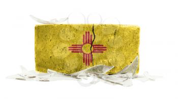 Brick with broken glass, violence concept, flag of New Mexico