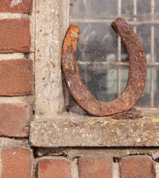 Single horseshoe in front of a window, bringing luck