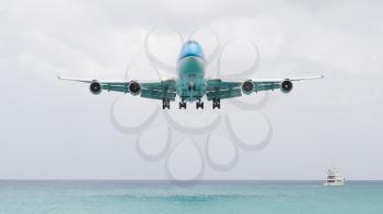 ST MARTIN, ANTILLES - JULY 19, 2013: Boeing 747 aircraft in is landing at Princess Juliana International Airport in Netherlands Antilles in July 19, 2013 in St Martin.