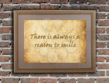 Old wooden frame with written text on an old wall - There is always a reason to smile