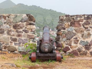 Very old rusted canon on top of an old wall, Caribbean