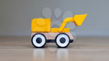 Simple wheel dozer toy, plastic and wood