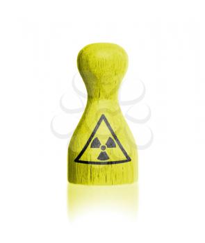 Wooden pawn with a painting, danger - radiation