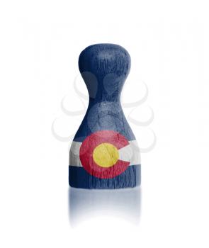 Wooden pawn with a painting of a flag, Colorado