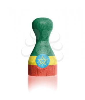 Wooden pawn with a painting of a flag, Ethiopia