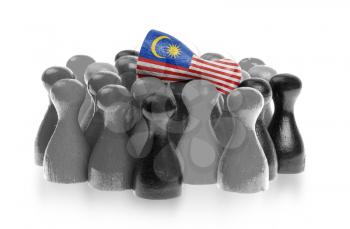 One unique pawn on top of common pawns, flag of Malaysia
