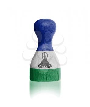 Wooden pawn with a painting of a flag, Lesotho