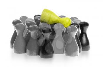 Yellow pawn is crowdsurfing over a collection of different colors of pawns