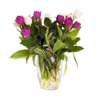 Messy bouquet of tulips in a glass vase