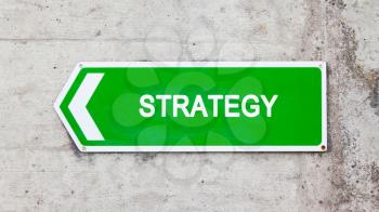 Green sign on a concrete wall - Strategy