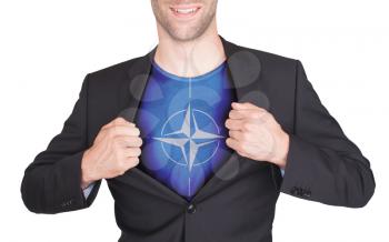Businessman opening suit to reveal shirt with flag, NATO