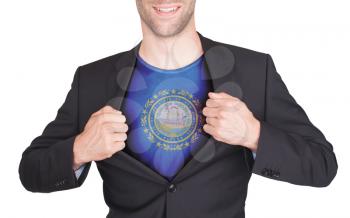 Businessman opening suit to reveal shirt with state flag (USA), New Hampshire