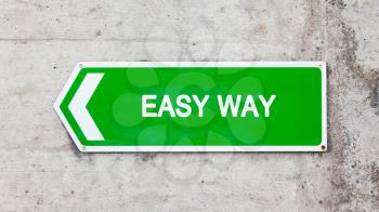 Green sign on a concrete wall - Easy way