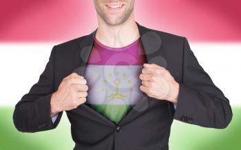 Businessman opening suit to reveal shirt with flag, Tajikistan