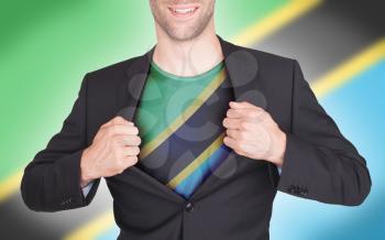 Businessman opening suit to reveal shirt with flag, Tanzania