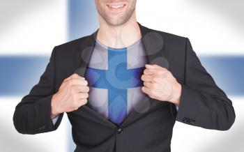 Businessman opening suit to reveal shirt with flag, Finland