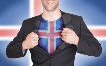 Businessman opening suit to reveal shirt with flag, Iceland
