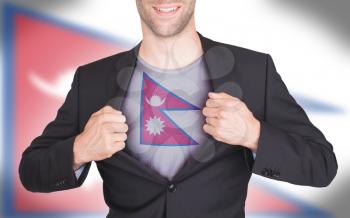 Businessman opening suit to reveal shirt with flag, Nepal