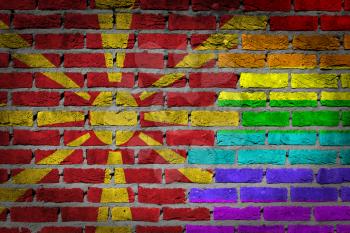 Dark brick wall texture - coutry flag and rainbow flag painted on wall - Macedonia