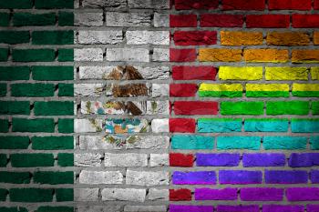 Dark brick wall texture - coutry flag and rainbow flag painted on wall - Mexico