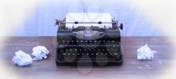 Vintage typewriter on wooden table, touch-up in retro style
