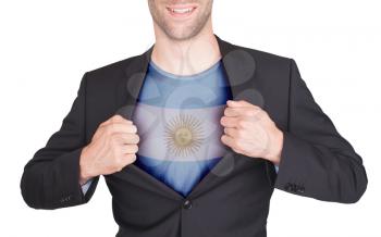 Businessman opening suit to reveal shirt with flag, Argentina