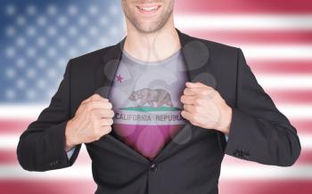 Businessman opening suit to reveal shirt with state flag (USA), California
