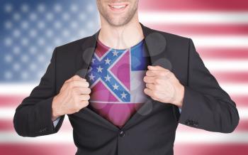 Businessman opening suit to reveal shirt with state flag (USA), Mississippi