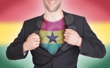 Businessman opening suit to reveal shirt with flag, Ghana